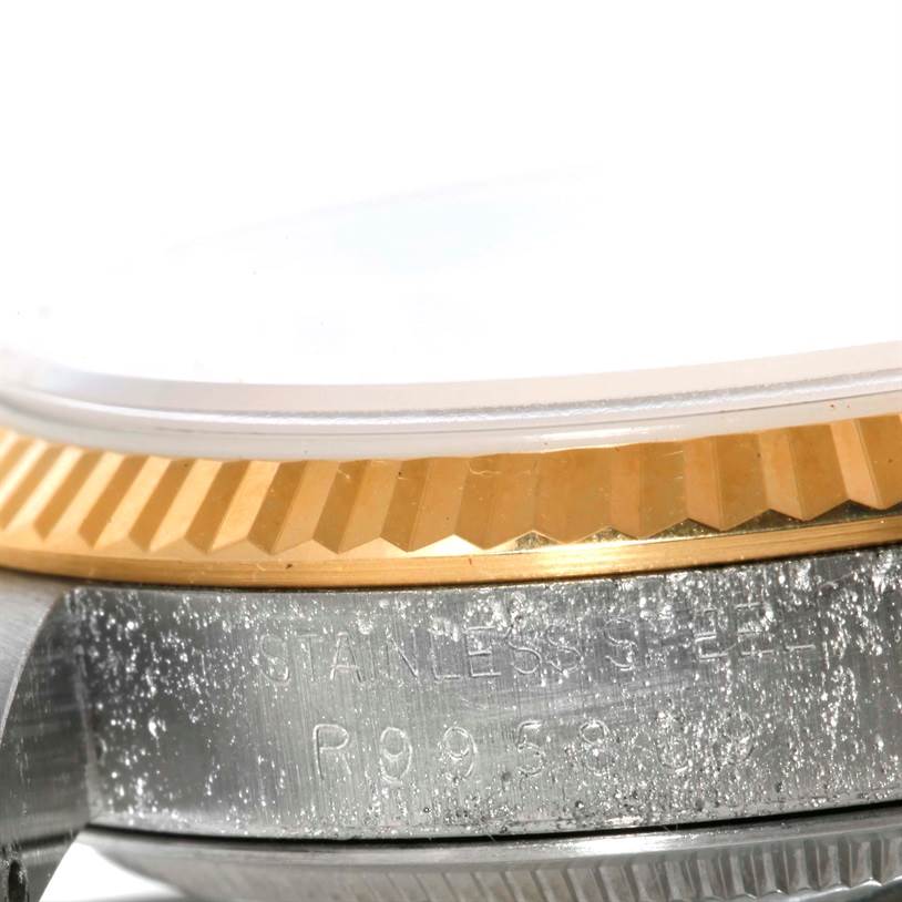 This image shows a close-up of the Rolex Datejust 16233 Men's Steel and Gold (two tone) Champagne Dial 16233 Men's Steel and Gold (two tone) Champagne Dial's case, focusing on the stainless steel and gold bezel.