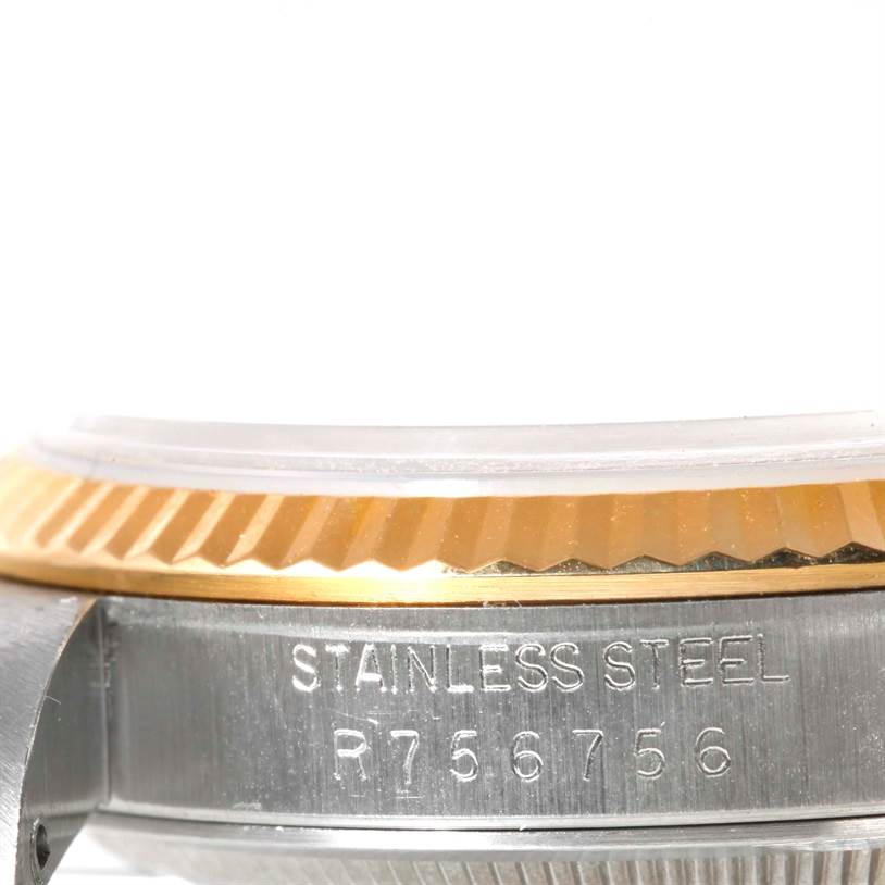 This image shows a close-up of the side of a Rolex Datejust 16233 Men
s Steel and Gold (two tone) White Dial 16233 Men
s Steel and Gold (two tone) White Dial watch, featuring its stainless steel case and gold fluted bezel.