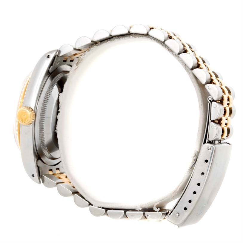 This image shows a Rolex Datejust 16233 Men
s Steel and Gold (two tone) White Dial 16233 Men
s Steel and Gold (two tone) White Dial watch from a side angle, highlighting the crown, case, and part of the bracelet.