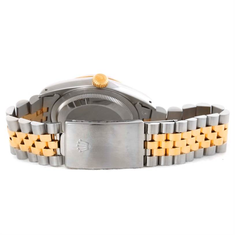 The image shows the clasp and case back of the Rolex Datejust 16233 Men
s Steel and Gold (two tone) White Dial 16233 Men
s Steel and Gold (two tone) White Dial watch, along with its two-tone bracelet from the back angle.