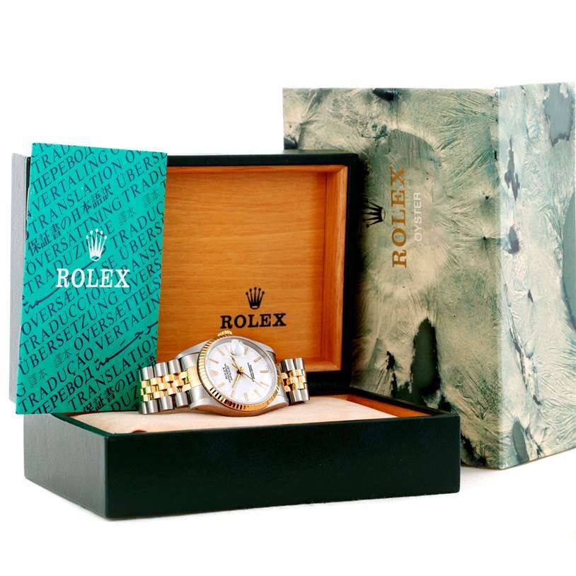 This image shows a Rolex Datejust 16233 Men
s Steel and Gold (two tone) White Dial 16233 Men
s Steel and Gold (two tone) White Dial watch at an oblique angle, inside its branded box with accompanying accessories.