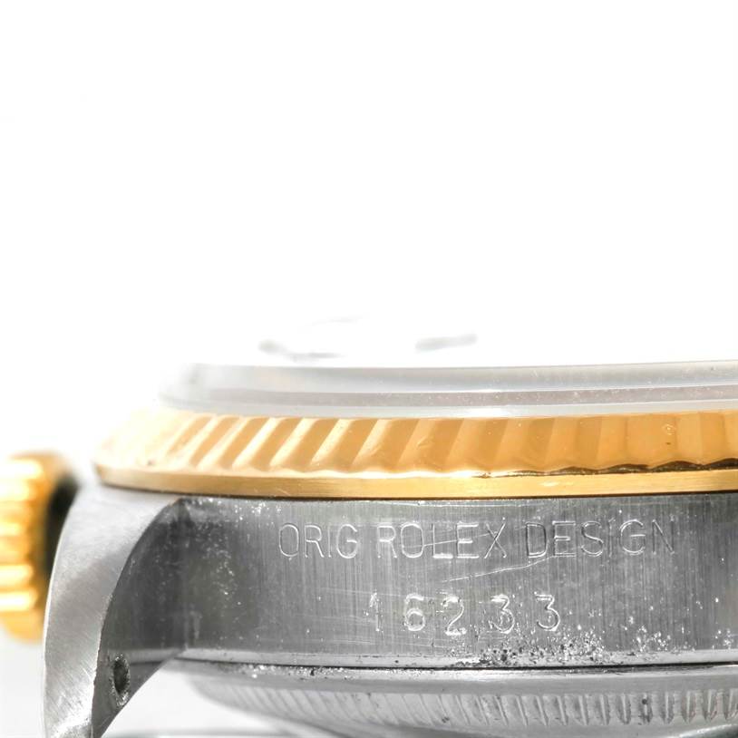 This image shows a close-up, side view of a Rolex Datejust 16233 Men
s Steel and Gold (two tone) Silver Dial 16233 Men
s Steel and Gold (two tone) Silver Dial watch, highlighting the bezel and case with model number 16233 engraved.