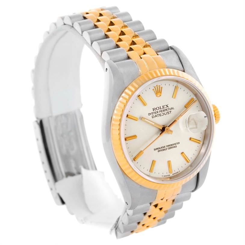 The Rolex Datejust 16233 Men
s Steel and Gold (two tone) Silver Dial 16233 Men
s Steel and Gold (two tone) Silver Dial watch is shown at an angle showcasing its face, bezel, crown, and two-tone bracelet.