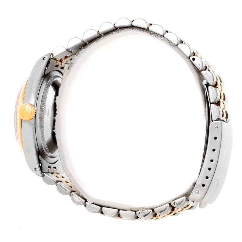 The image shows a side view of a Rolex Datejust 16233 Men
s Steel and Gold (two tone) Silver Dial 16233 Men
s Steel and Gold (two tone) Silver Dial watch, highlighting its crown, case, and bracelet.