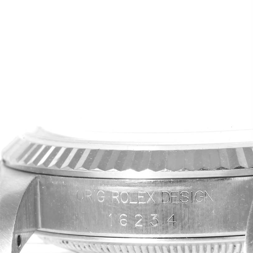 This image shows a close-up side view of a Rolex Datejust 16234 Men's Stainless Steel Silver Dial 16234 Men's Stainless Steel Silver Dial model, highlighting the engraving "ORIG ROLEX DESIGN 16234".