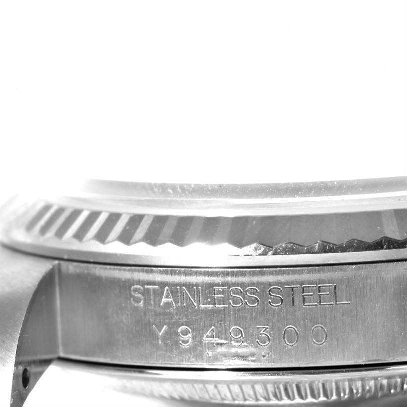 This image shows a side view of a Rolex Datejust 16234 Men
s Stainless Steel Pink Dial 16234 Men
s Stainless Steel Pink Dial watch, focusing on the engraved serial number and stainless steel marking.