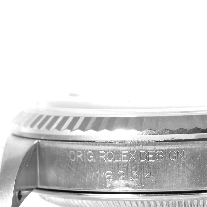 The image shows a side view of the case and part of the bezel of a Rolex Datejust 16234 Men
s Stainless Steel Pink Dial 16234 Men
s Stainless Steel Pink Dial watch, with "ORIG. ROLEX DESIGN 16234" engraved.