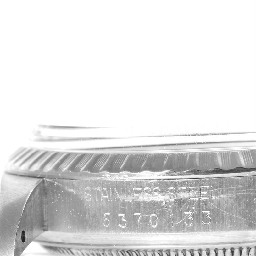 This image shows a close-up view of the side of a stainless steel Rolex Datejust 1603 Men's Stainless Steel Silver Dial 1603 Men's Stainless Steel Silver Dial watch's case, featuring the serial number.