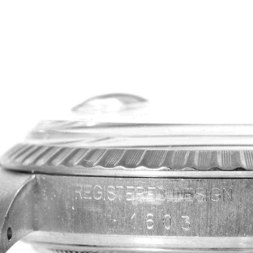 The image shows a close-up side angle of a Rolex Datejust 1603 Men's Stainless Steel Silver Dial 1603 Men's Stainless Steel Silver Dial watch case, highlighting the fluted bezel and the model number engraving.