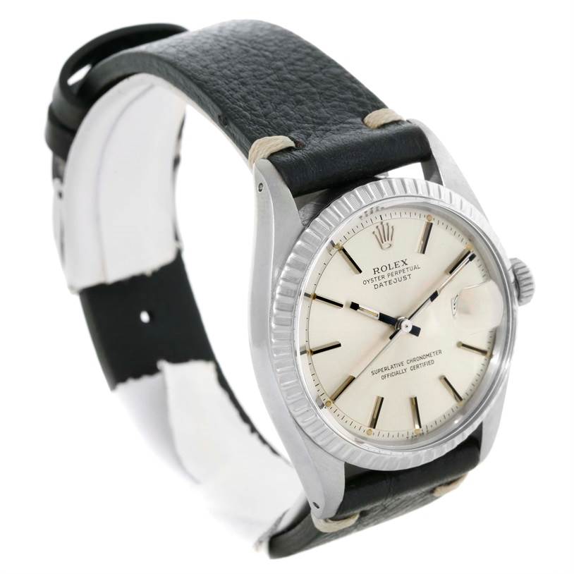 This image shows a Rolex Datejust 1603 Men's Stainless Steel Silver Dial 1603 Men's Stainless Steel Silver Dial watch at an angle displaying the dial, fluted bezel, and leather strap.