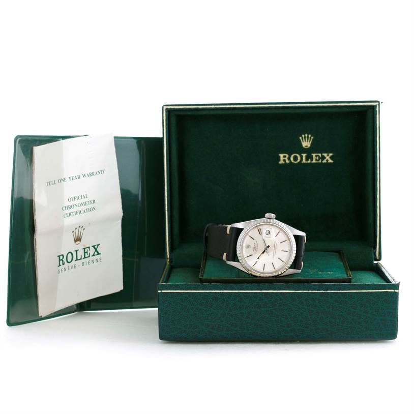 The image shows a Rolex Datejust 1603 Men's Stainless Steel Silver Dial 1603 Men's Stainless Steel Silver Dial watch at a slight angle inside its open green box, with certification papers on the left.