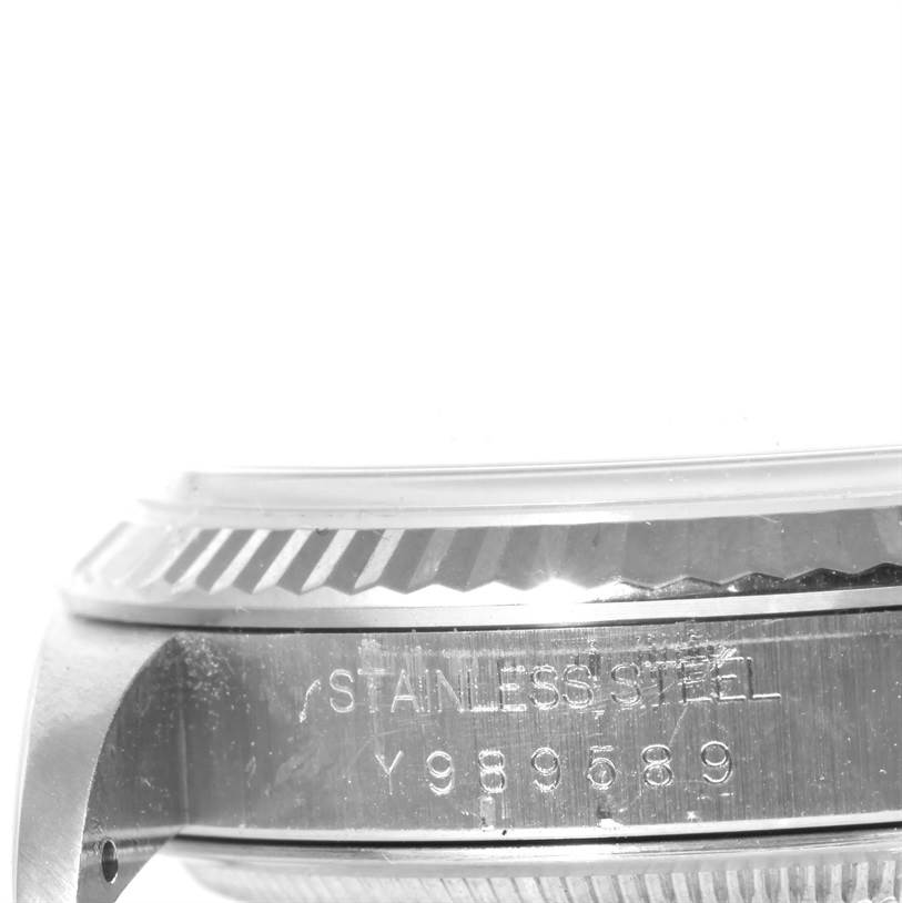 The image shows a close-up side view of the bezel and case of a Rolex Datejust 16234 Men's Stainless Steel Silver Dial 16234 Men's Stainless Steel Silver Dial watch, highlighting the stainless steel material and serial number.