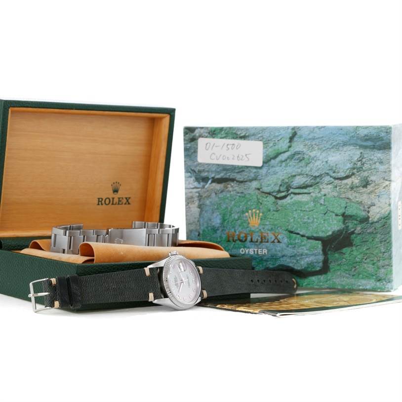 The image shows a Rolex Datejust 16234 Men's Stainless Steel Silver Dial 16234 Men's Stainless Steel Silver Dial watch and its accessories, including the case, extra strap, and original packaging, viewed from a slight side angle.