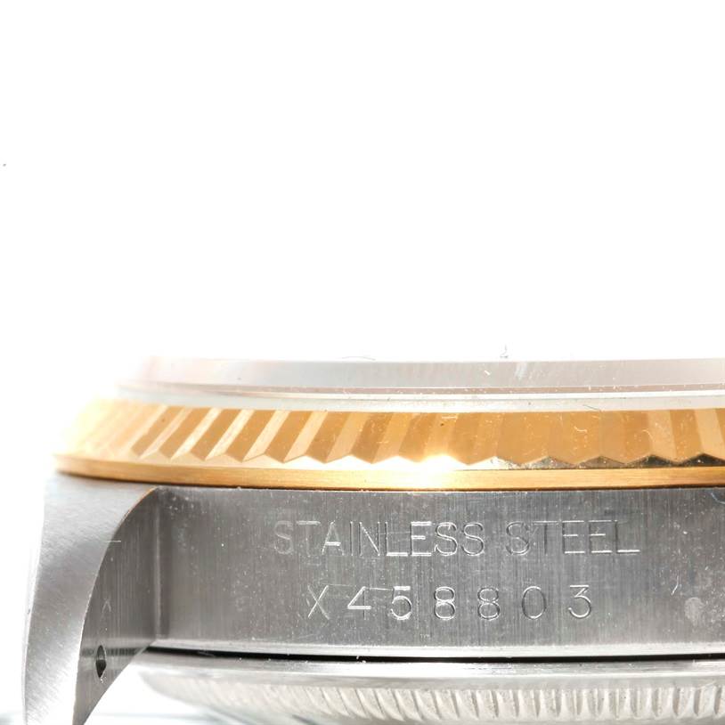 The image shows a close-up side view of the case and bezel of a Rolex Datejust 16233 Men's Steel and Gold (two tone) Champagne Dial 16233 Men's Steel and Gold (two tone) Champagne Dial watch, highlighting the stainless steel and serial number.