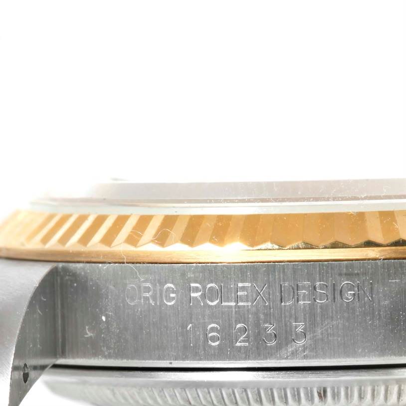 The image shows a close-up side view of the Rolex Datejust 16233 Men's Steel and Gold (two tone) Champagne Dial 16233 Men's Steel and Gold (two tone) Champagne Dial case, highlighting the model number and the edge of the bezel.
