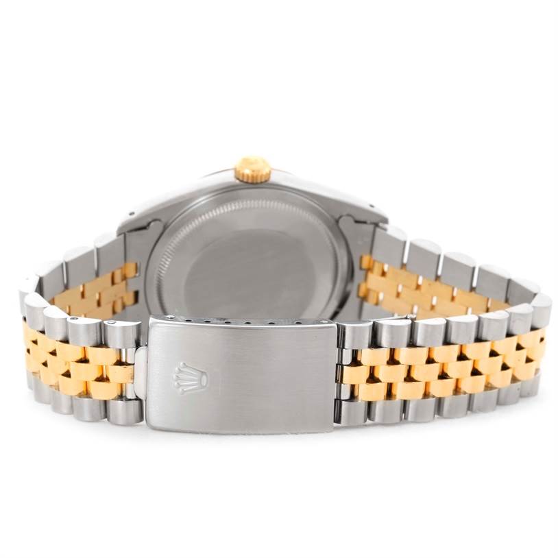 This image shows the back case and two-tone bracelet of a Rolex Datejust 16233 Men's Steel and Gold (two tone) Champagne Dial 16233 Men's Steel and Gold (two tone) Champagne Dial watch, including the clasp with the Rolex logo.