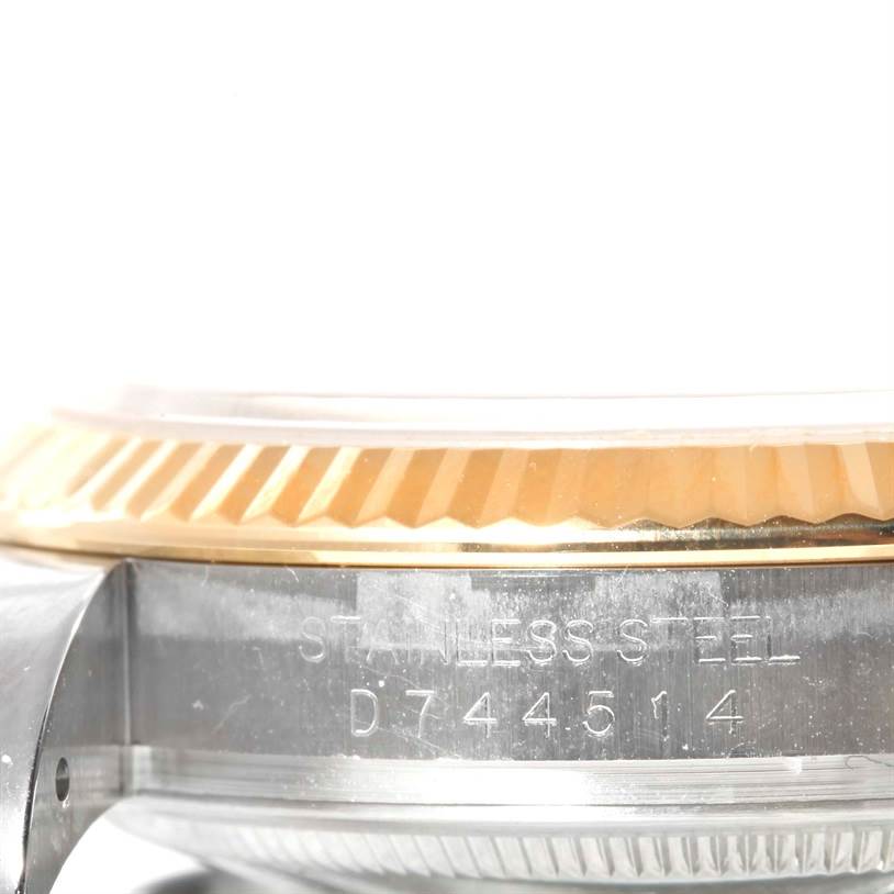 This image shows a close-up side view of the stainless steel case and fluted bezel of a Rolex Datejust 116233 Men
s Stainless Steel Champagne Dial 116233 Men
s Stainless Steel Champagne Dial watch.