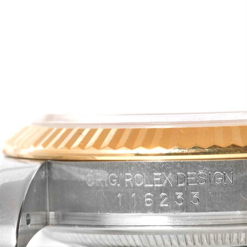 The image shows a close-up side view of the bezel and case of a Rolex Datejust 116233 Men
s Stainless Steel Champagne Dial 116233 Men
s Stainless Steel Champagne Dial watch, with the model number engraved.