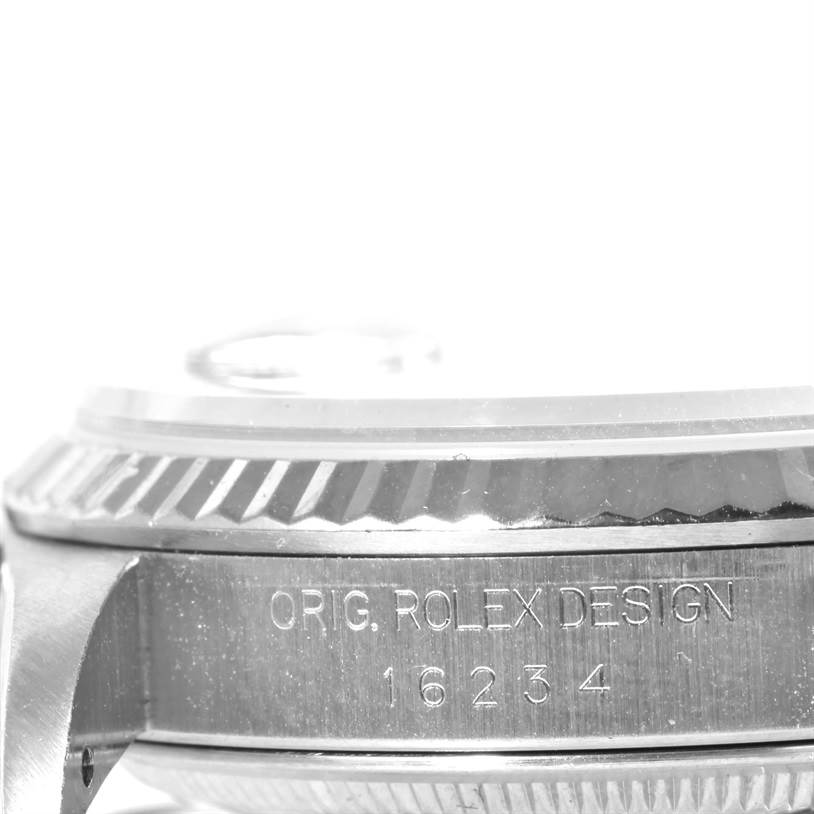 This image shows the side of the Rolex Datejust 16234 Men's Stainless Steel Blue Dial 16234 Men's Stainless Steel Blue Dial watch case with the model number 16234 and "ORIG. ROLEX DESIGN" engraving.