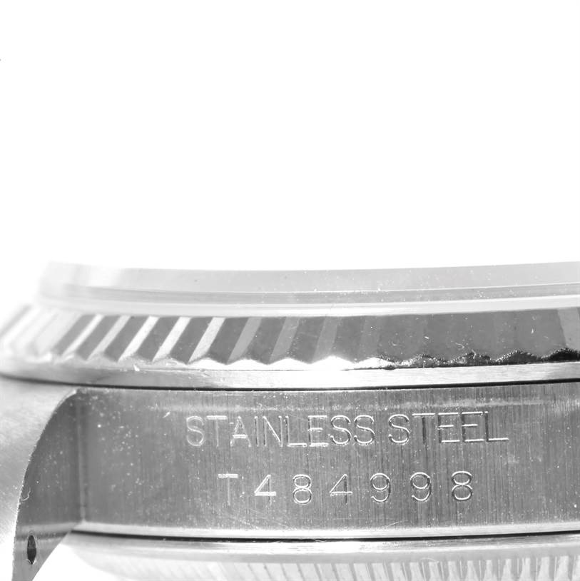 The image shows a close-up side view of the stainless steel case and bezel of a Rolex Datejust 16234 Men's Stainless Steel Blue Dial 16234 Men's Stainless Steel Blue Dial watch, displaying the serial number.
