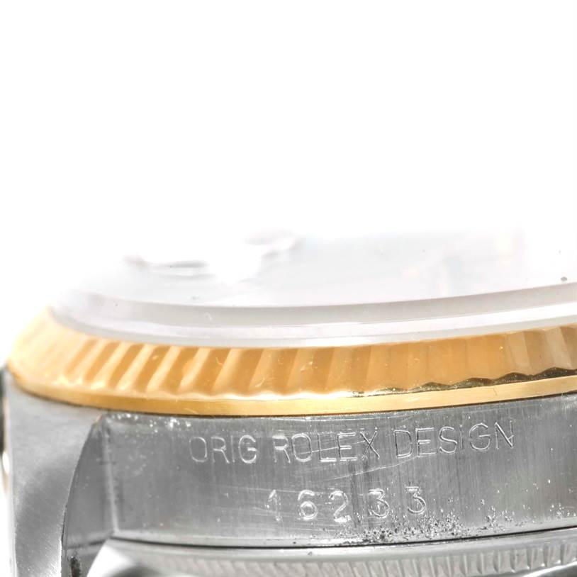 This angle of the Rolex Datejust 16233 Men's Steel and Gold (two tone) Silver Dial 16233 Men's Steel and Gold (two tone) Silver Dial watch shows a close-up of the side, focusing on the bezel and engraved model number (16233).