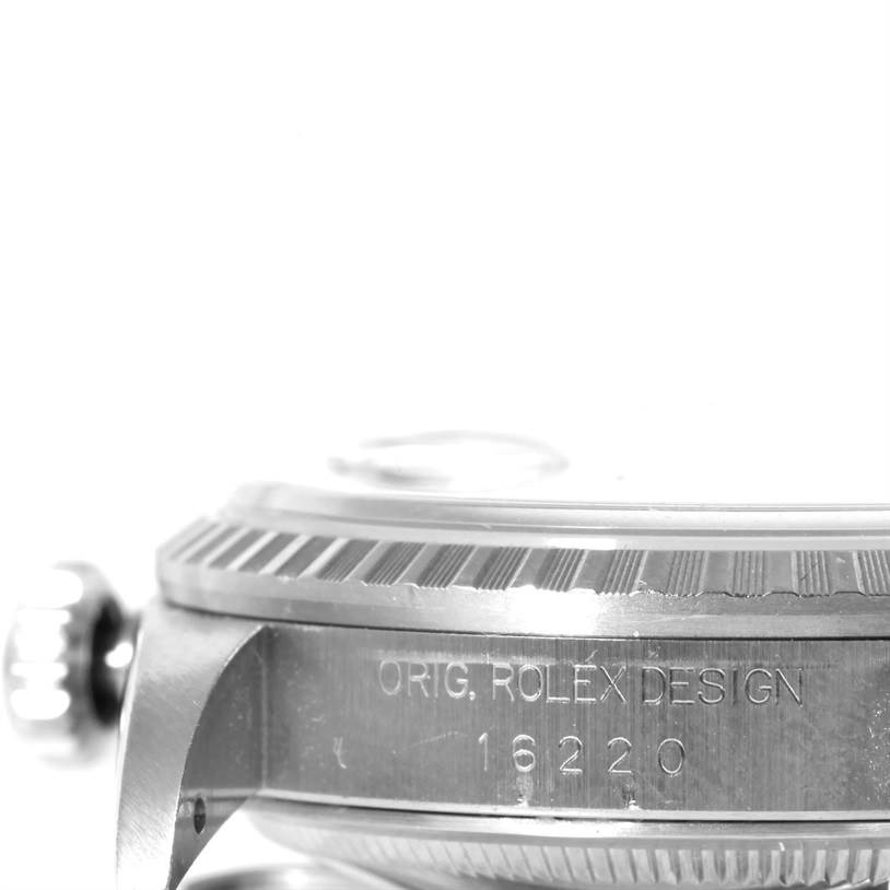This image shows a close-up view of the Rolex Datejust 16220 Men
s Stainless Steel Black Dial 16220 Men
s Stainless Steel Black Dial watch
s side, featuring the bezel, crown, engravings, and model number 16220.