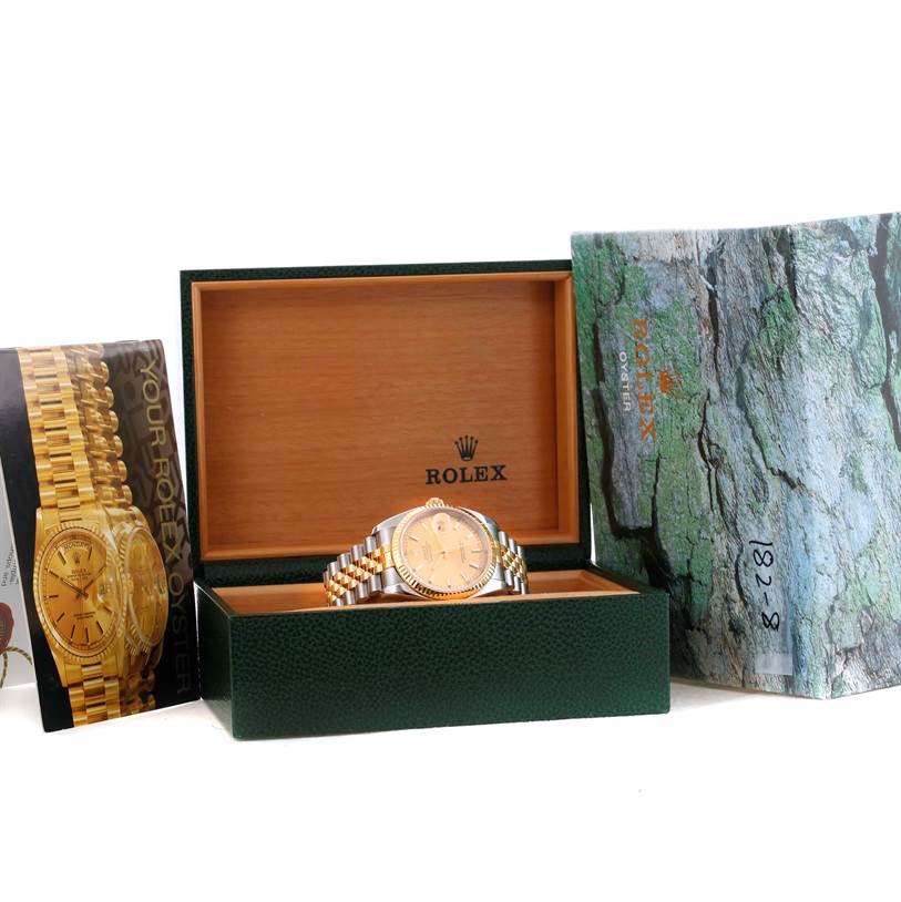 The image shows a Rolex Datejust 116233 Men's Stainless Steel Champagne Dial 116233 Men's Stainless Steel Champagne Dial watch positioned in an open green and wooden Rolex box, with accompanying booklets.