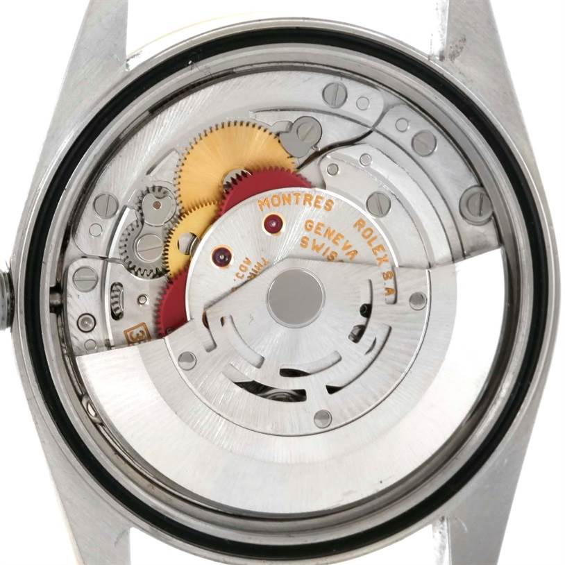 The image shows the internal mechanism of a Rolex Datejust 16233 Men's Steel and Gold (two tone) White Dial 16233 Men's Steel and Gold (two tone) White Dial watch from the back, featuring gears and the rotor.