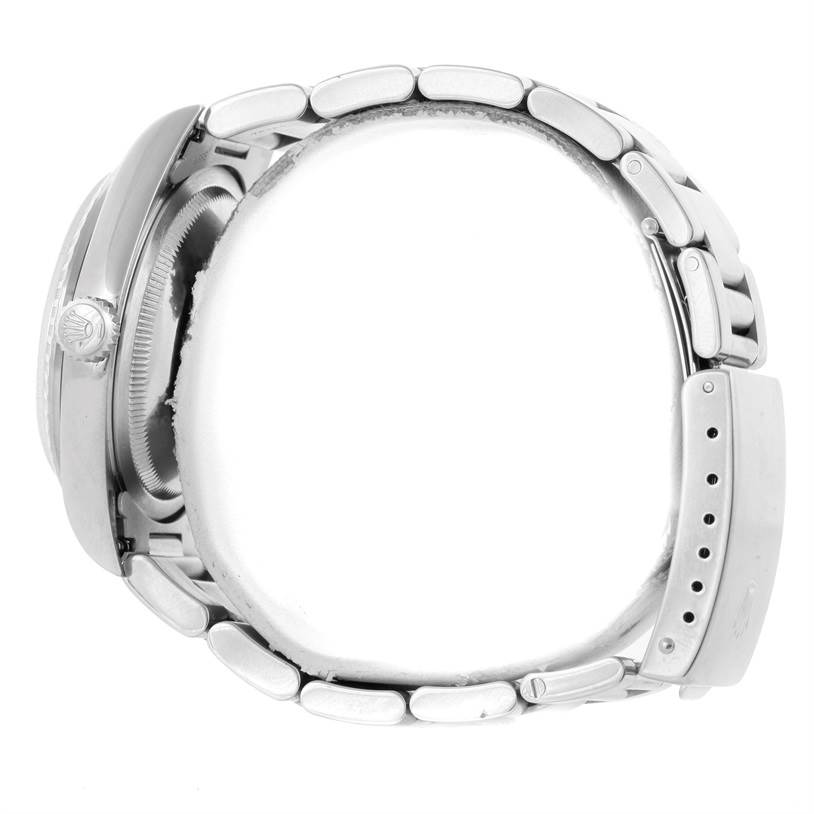 This side-angle view of the Rolex Datejust 16220 Men
s Stainless Steel Blue Dial 16220 Men
s Stainless Steel Blue Dial shows the crown, case, and bracelet.