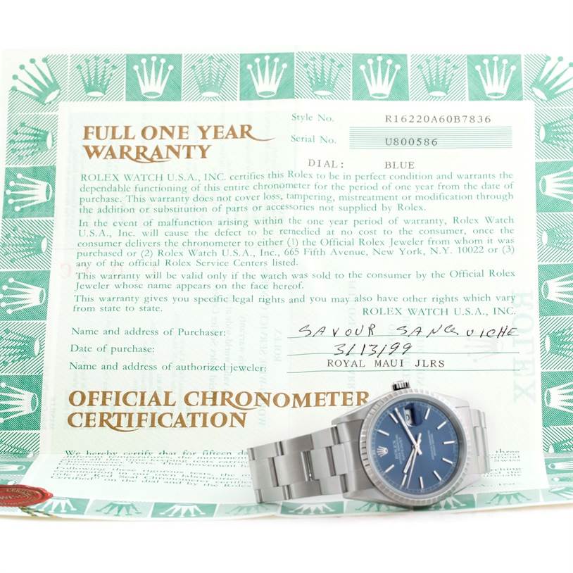 This image shows a Rolex Datejust 16220 Men
s Stainless Steel Blue Dial 16220 Men
s Stainless Steel Blue Dial watch with a blue dial, positioned on top of its official chronometer certification and warranty documentation.