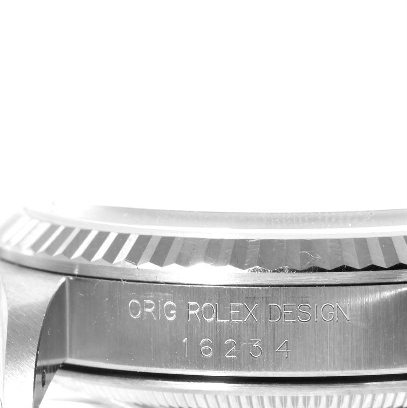 This image shows a close-up side view of the bezel and case of a Rolex Datejust 16234 Men's Stainless Steel White Dial 16234 Men's Stainless Steel White Dial model, displaying the engraving "ORIG ROLEX DESIGN 16234".