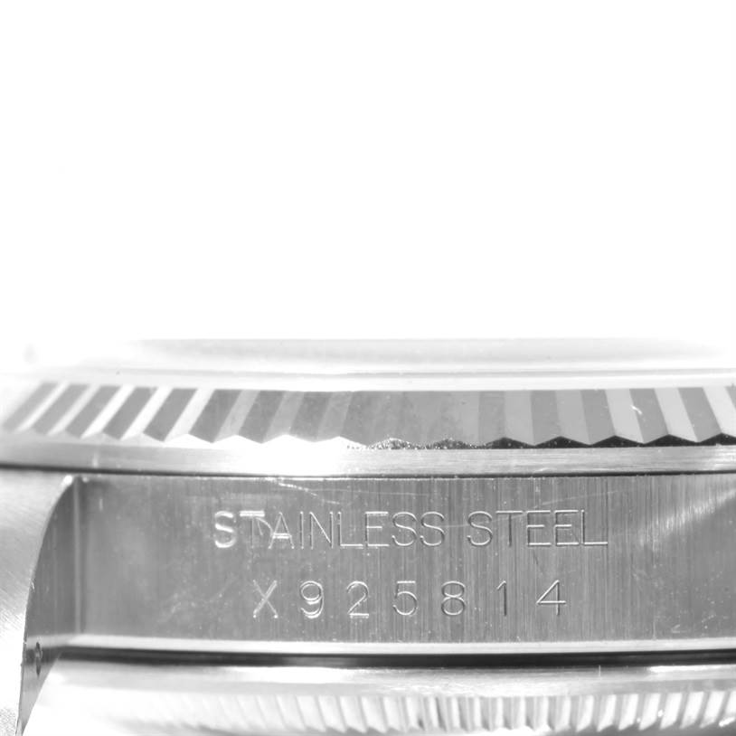 The image shows a close-up side view of the casing and bezel of a Rolex Datejust 16234 Men's Stainless Steel White Dial 16234 Men's Stainless Steel White Dial watch, highlighting the stainless steel inscription and serial number.