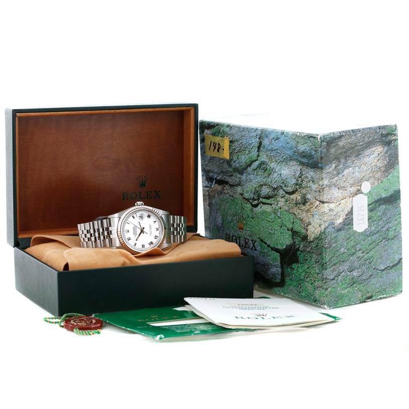 The Datejust Rolex watch is shown inside an open box with its packaging, booklets, and hang tags.