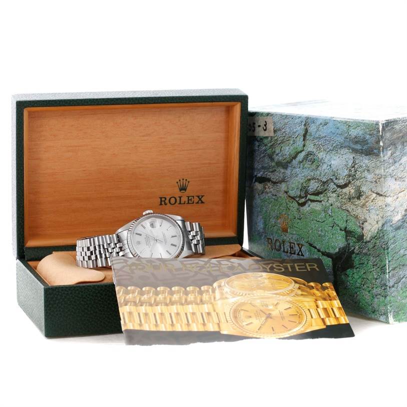 The Rolex Datejust 16234 Men's Stainless Steel Silver Dial 16234 Men's Stainless Steel Silver Dial watch is shown in an open watch box with its bracelet visible, accompanied by an outer box and brochure.