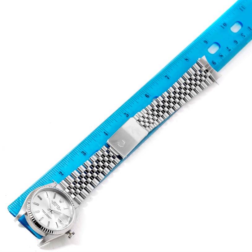 This image shows a top-down view of the Rolex Datejust 16234 Men's Stainless Steel Silver Dial 16234 Men's Stainless Steel Silver Dial watch with its bracelet next to a ruler for measurement.