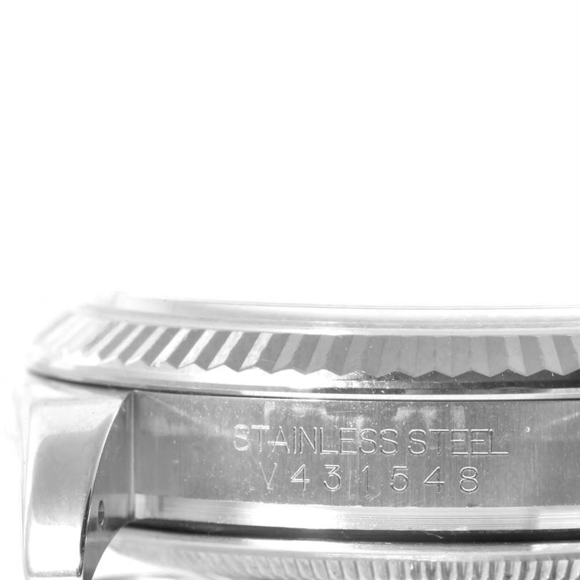 This image shows a close-up of the engraving on the stainless steel case side and bezel of a Rolex Datejust 116234 Men's Stainless Steel White Dial 116234 Men's Stainless Steel White Dial watch.