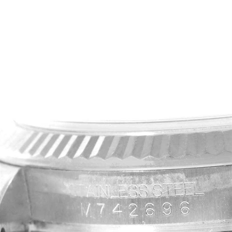 The image shows a close-up of the stainless steel fluted bezel and part of the case back of a Rolex Datejust 116234 Men's Stainless Steel Silver Dial 116234 Men's Stainless Steel Silver Dial watch.
