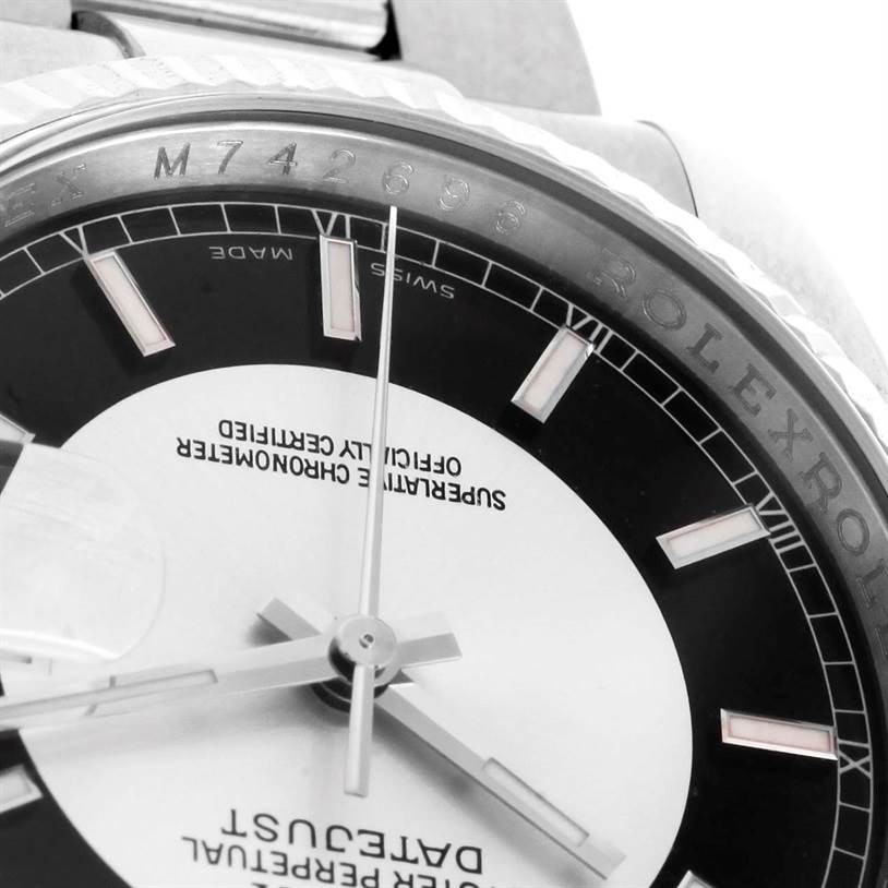 This close-up angle of the Rolex Datejust 116234 Men's Stainless Steel Silver Dial 116234 Men's Stainless Steel Silver Dial watch shows part of the dial, the hour markers, the hands, and the serial number on the bezel.