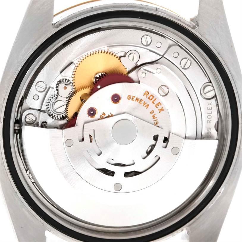 The image shows the back view of a Rolex Datejust 116203 Men's Stainless Steel Grey Dial 116203 Men's Stainless Steel Grey Dial watch, displaying its internal movement and gears.