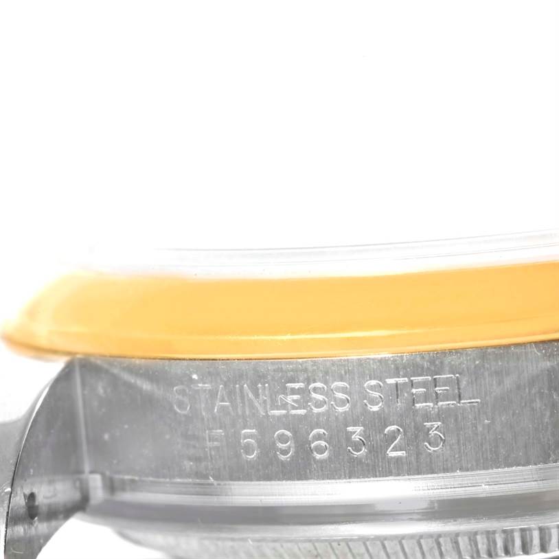 This image shows a close-up side view of the casing of a Rolex Datejust 116203 Men's Stainless Steel Grey Dial 116203 Men's Stainless Steel Grey Dial, highlighting the "Stainless Steel" engraving and serial number.