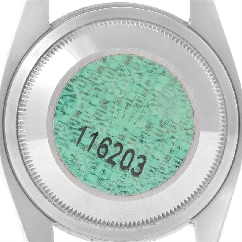 This image shows the case back and serial number of a Rolex Datejust 116203 Men's Stainless Steel Grey Dial 116203 Men's Stainless Steel Grey Dial model watch from a top angle.