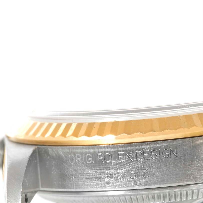 This image shows a close-up side view of the bezel and casing with engraving on a Rolex Datejust 16233 Men's Steel and Gold (two tone) Silver Dial 16233 Men's Steel and Gold (two tone) Silver Dial watch.