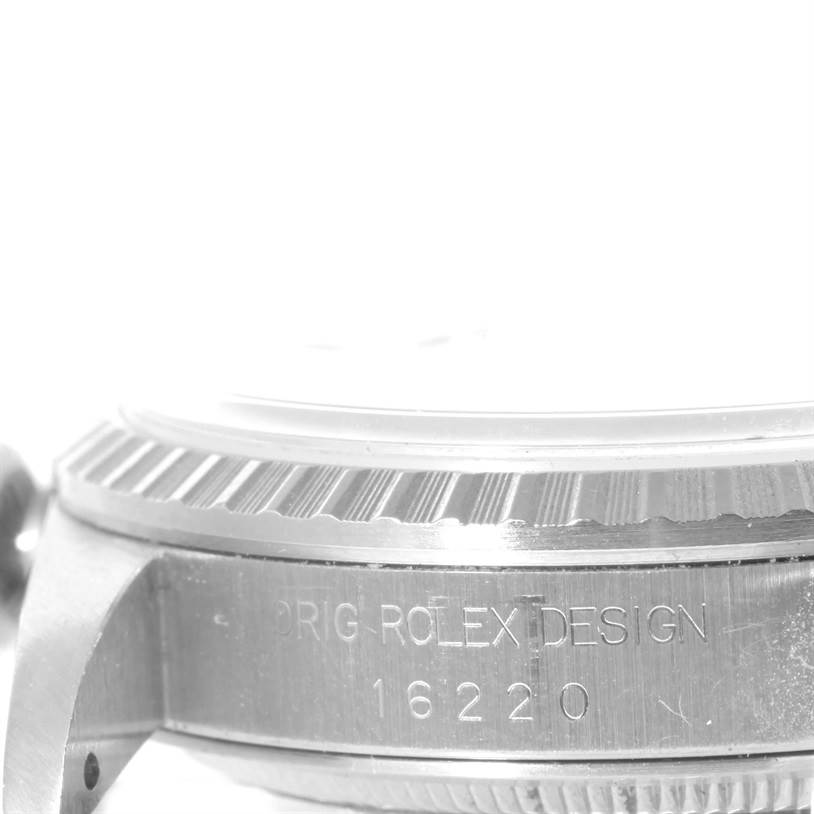 The image shows a close-up of the side case and bezel of a Rolex Datejust 16220 Men
s Stainless Steel White Dial 16220 Men
s Stainless Steel White Dial watch, with the model number engraved.