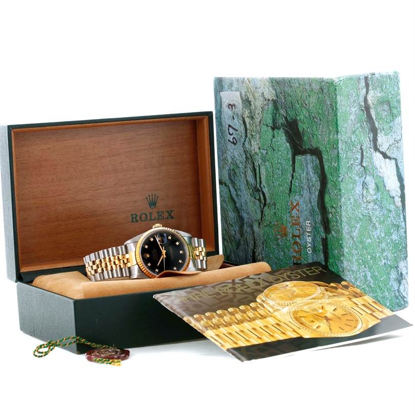 The image shows a Rolex Datejust 16233 Men's Steel and Gold (two tone) Black Dial 16233 Men's Steel and Gold (two tone) Black Dial watch with a black dial in an open box, alongside manuals and packaging.