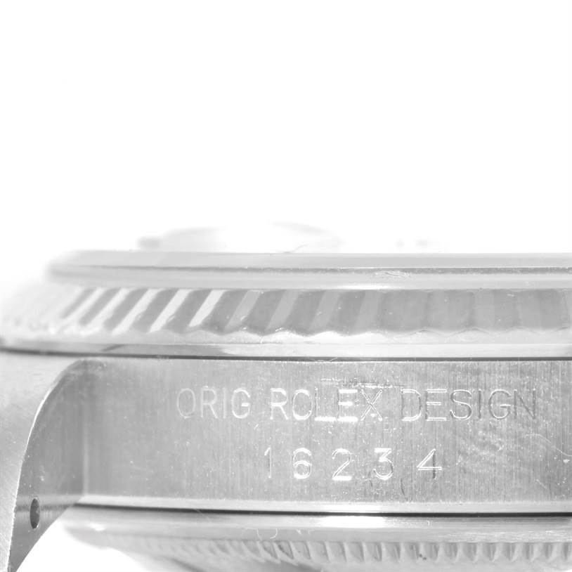 The image shows a close-up side view of the case and fluted bezel of a Rolex Datejust 16234 Men
s Stainless Steel Black Dial 16234 Men
s Stainless Steel Black Dial model, showcasing the engraving.