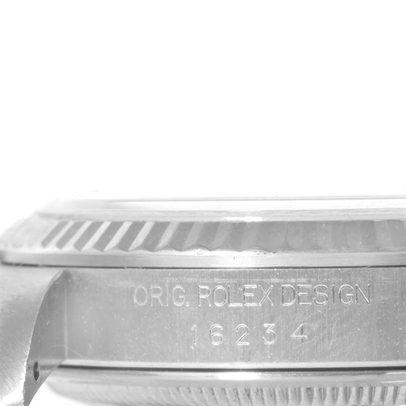 This image shows a close-up, side view of the bezel and case of a Rolex Datejust 16234 Men's Stainless Steel White Dial 16234 Men's Stainless Steel White Dial watch, with model number 16234 engraved.
