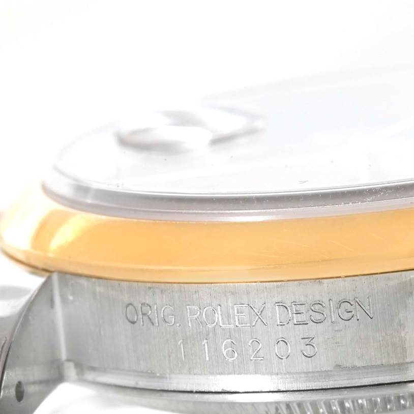 The image shows a side view of a Rolex Datejust 116203 Men's Stainless Steel Black Dial 116203 Men's Stainless Steel Black Dial watch case, highlighting the bezel and the "ORIG. ROLEX DESIGN" engraving with the model number 116203.