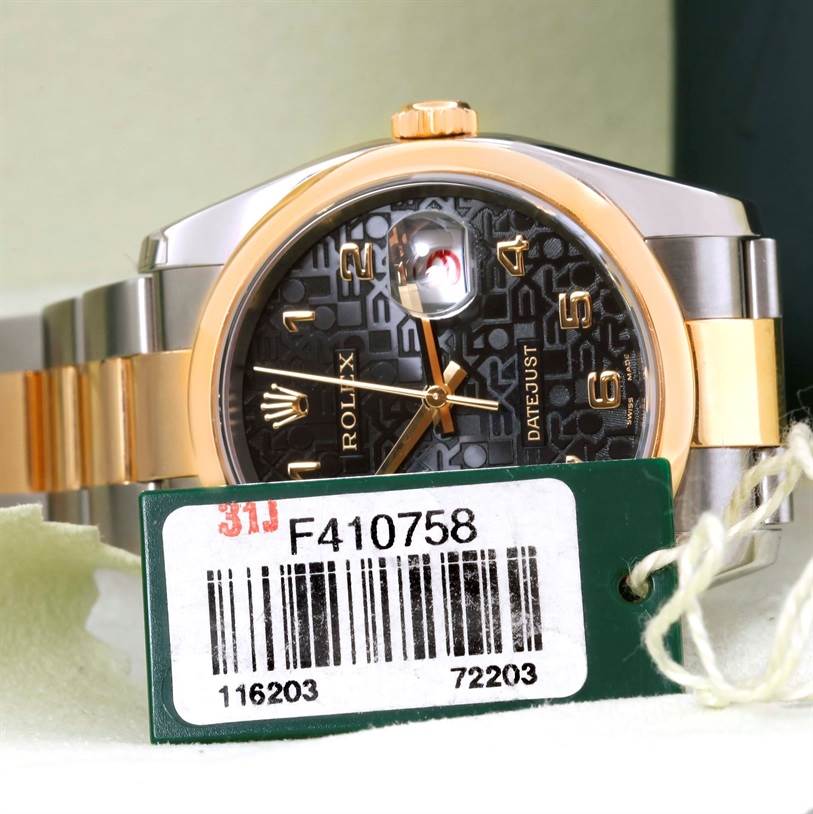 The image shows a close-up of the Rolex Datejust 116203 Men's Stainless Steel Black Dial 116203 Men's Stainless Steel Black Dial watch face and part of the bracelet, along with an identification tag in the foreground.