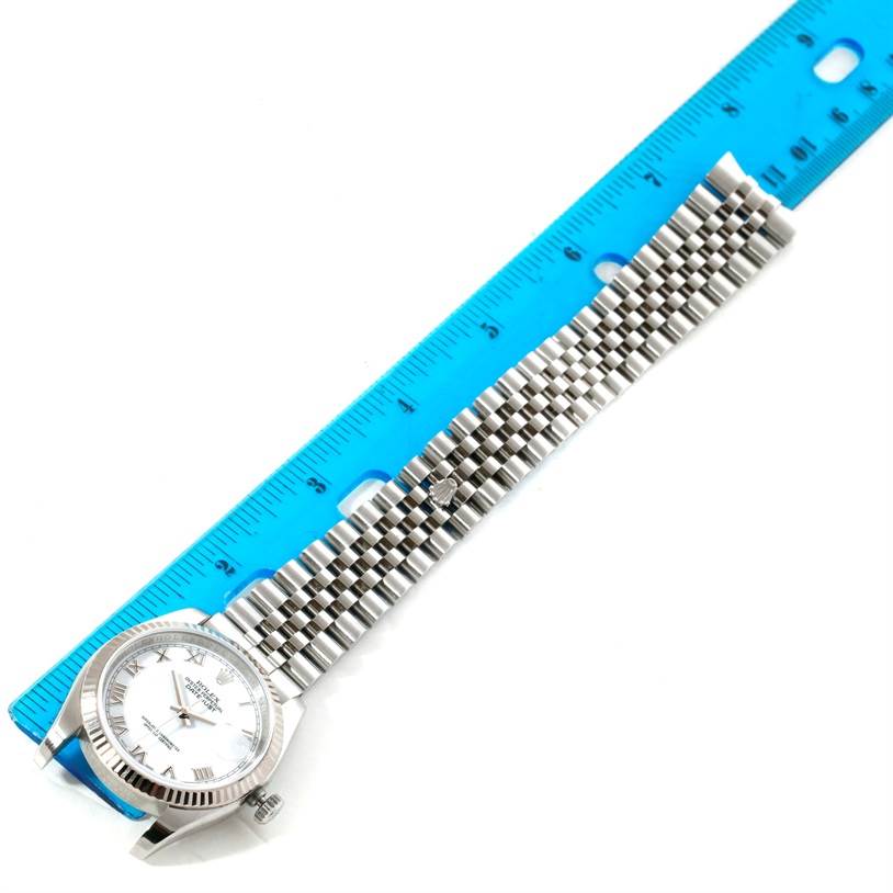 The image shows a top-down view of a Rolex Datejust 116234 Men's Stainless Steel White Dial 116234 Men's Stainless Steel White Dial watch with its face and Jubilee bracelet.