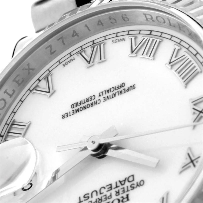The image shows a close-up of the face and part of the bezel of a Rolex Datejust 116234 Men's Stainless Steel White Dial 116234 Men's Stainless Steel White Dial, highlighting Roman numerals and the hands.